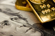 Close-up of a 20-dollar banknote and gold bullions