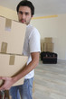 Man carrying boxes during house move