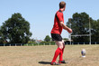 Photo: A rugbyman practicing his kick. A rugbyman practicing his kick.