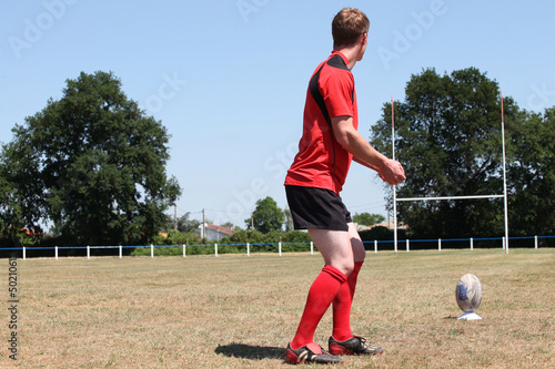 Photo: A rugbyman practicing his kick. A rugbyman practicing his kick.