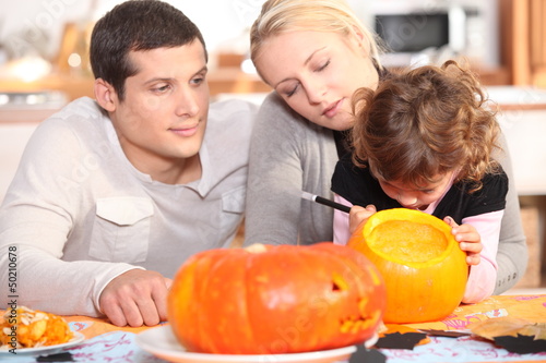Photo: Family preparing pumpkins for Halloween Family preparing pumpkins for Halloween