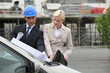A team of engineers looking at a technical drawing
