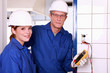 electrician and his colleague checking an electrical outlet