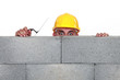 Workers peeking behind wall