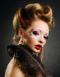 Beautiful girl with a mask and make up on gray background