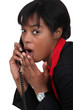 black businesswoman on the phone  shocked at sensational news