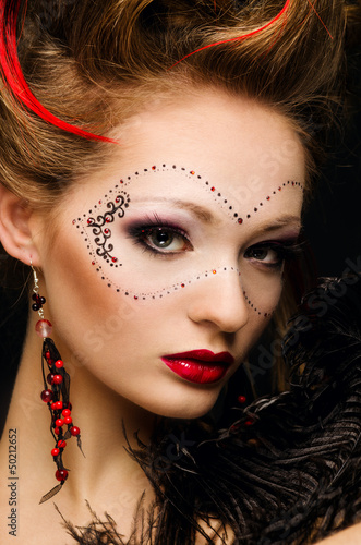 Photo: Beautiful girl with a mask and make up on gray background Beautiful girl with a mask and make up on gray background