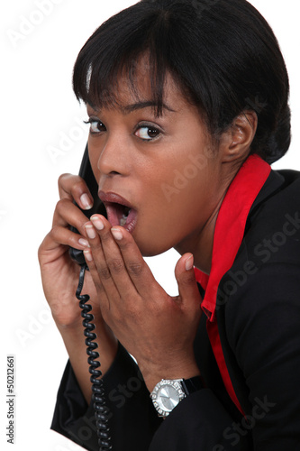 Photo: black businesswoman on the phone shocked at sensational news black businesswoman on the phone shocked at sensational news