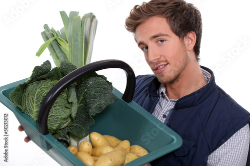 Photo: portrait of a gardener with vegetables portrait of a gardener with vegetables