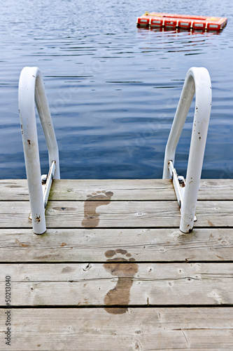 Photo: Footprints on dock at summer lake Footprints on dock at summer lake