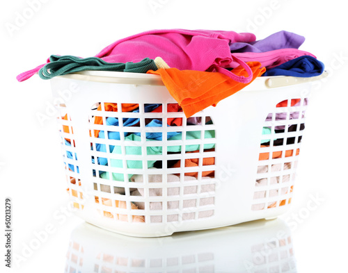 Photo: Clothes in plastic basket isolated on white Clothes in plastic basket isolated on white
