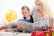 Woman reading a book to her son