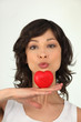 Photo: Woman kissing a heart Woman kissing a heart