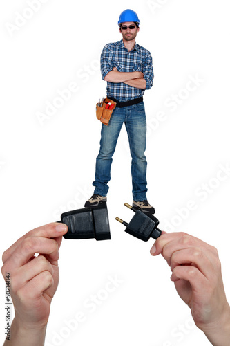 Photo: Cool electrician standing on a plug Cool electrician standing on a plug