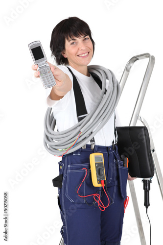 Photo: Tradeswoman holding a mobile phone Tradeswoman holding a mobile phone