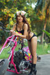 Young sexy Asian woman in black lingerie on pink motorcycle
