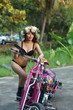 Young sexy Asian woman in black lingerie on pink motorcycle