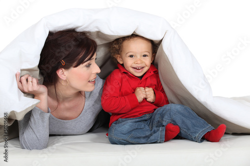 Photo: Mother and son hiding under blanket Mother and son hiding under blanket
