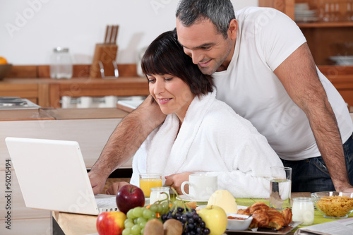Photo: happy couple having breakfast happy couple having breakfast