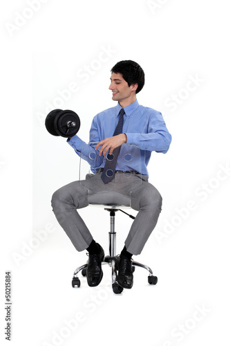 Photo: Businessman lifting weights Businessman lifting weights