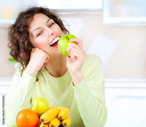 Photo: Dieting concept. Healthy Food. Young Woman Eats Fresh Fruit Dieting concept. Healthy Food. Young Woman Eats Fresh Fruit