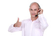 Man wearing headphones giving the thumb's up