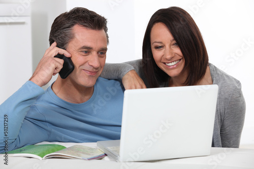 Photo: Couple shopping over the telephone Couple shopping over the telephone