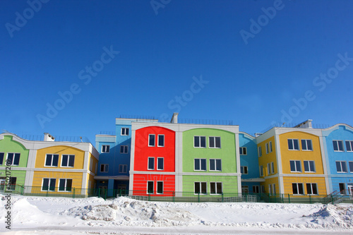 Photo: Modern colorful houses against a blue sky in the winter Modern colorful houses against a blue sky in the winter