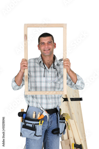 Photo: Carpenter showing wood frame Carpenter showing wood frame
