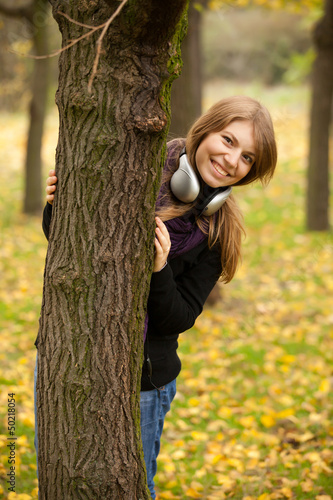 Photo: Portrait of girl with headphones at outdoor Portrait of girl with headphones at outdoor