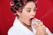 Woman with curlers and lit cigarette