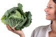 Smiling woman with cauliflower in the hand