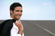 Businessman stood on empty road