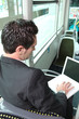 businessman in the bus working on his laptop