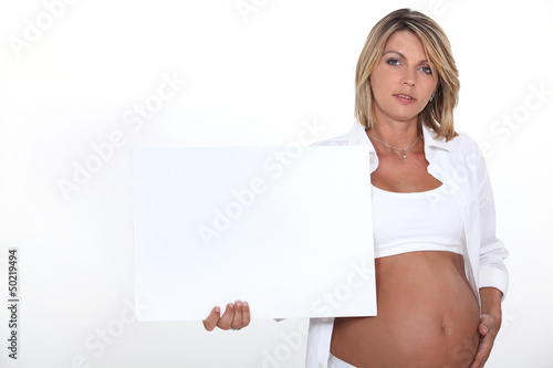 Photo: Pregnant woman with white poster Pregnant woman with white poster