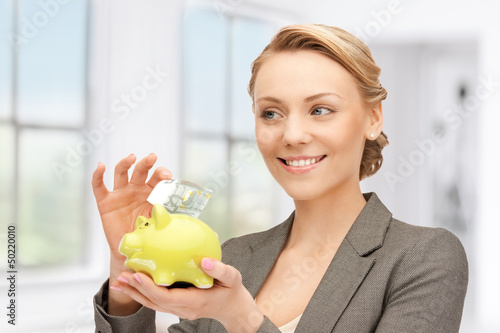 Photo: lovely woman with piggy bank and money lovely woman with piggy bank and money