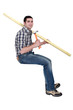 Joiner sat with plank of wood and hammer