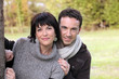 Couple stood by tree in park
