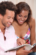 Couple excitedly looking at a catalogue