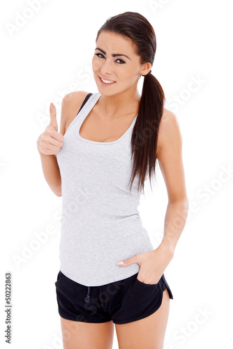 Photo: Sporty woman showing thumb up gesture Sporty woman showing thumb up gesture