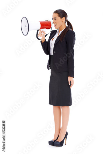 Photo: Business woman screaming loudly thru big megaphone Business woman screaming loudly thru big megaphone