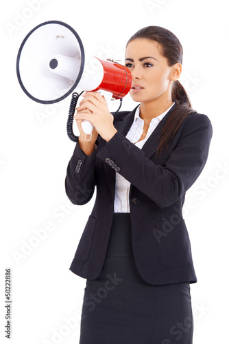Photo: Business woman screaming loudly thru big megaphone Business woman screaming loudly thru big megaphone