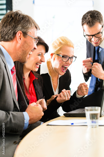 Photo: Business people looking at laptop with success Business people looking at laptop with success