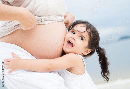Photo: Girl loving her pregnant mother Girl loving her pregnant mother