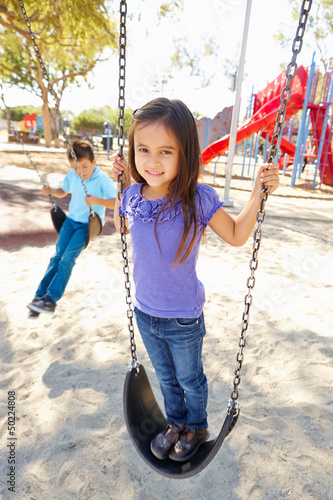 Photo: Boy And Girl Playing On Swing In Park Boy And Girl Playing On Swing In Park