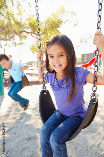 Photo: Boy And Girl Playing On Swing In Park Boy And Girl Playing On Swing In Park