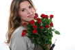 Woman with a bunch of red roses