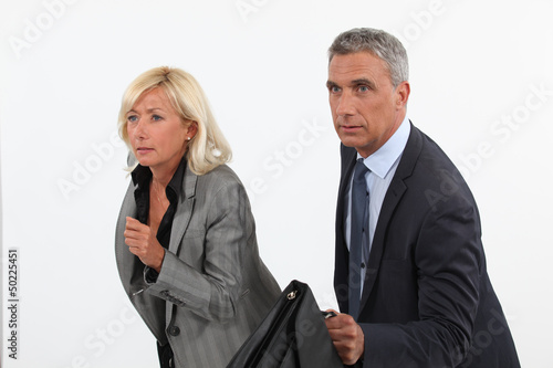 Photo: Businessman and businesswoman ready to race Businessman and businesswoman ready to race