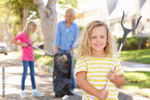 Photo: Mother And Daughters Picking Up Litter In Suburban Street Mother And Daughters Picking Up Litter In Suburban Street