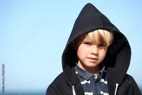 Photo: Little boy against a blue sky Little boy against a blue sky